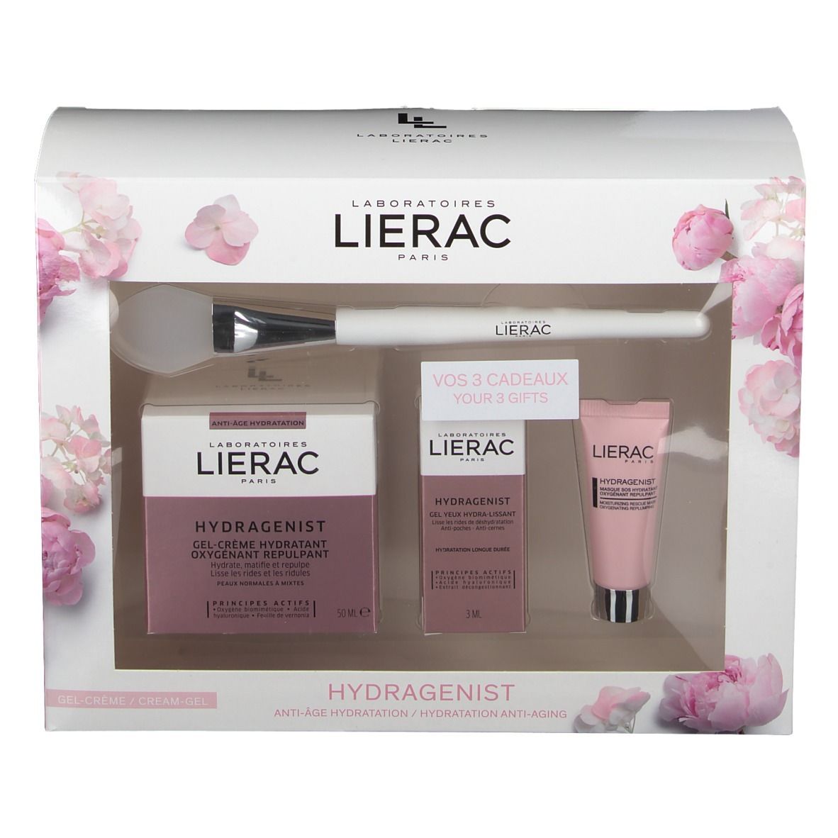 Coffret cadeau avec produits cosmétiques et pinceau. Emballage rose et blanc avec motifs floraux. Marque Lierac.