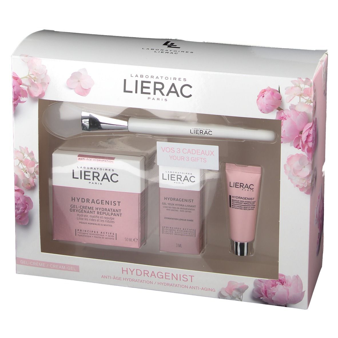 Coffret cadeau avec produits cosmétiques et pinceau. Emballage rose et blanc avec motifs floraux. Marque Lierac.