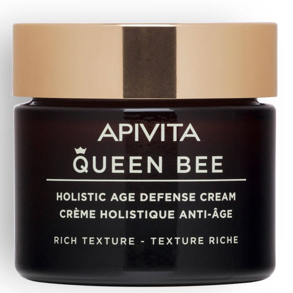 Pot de crème brun foncé avec couvercle doré. Inscription : Apivita Queen Bee, Holistic Age Defense Cream.