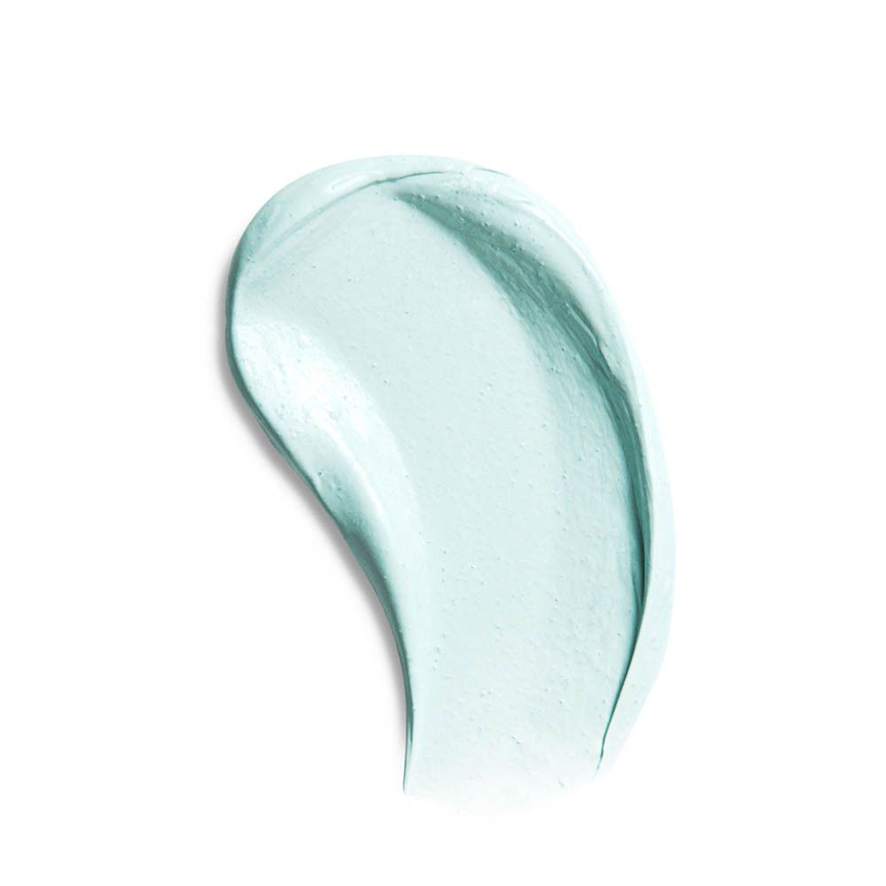 Une touche de fond de teint vert clair sur fond blanc.