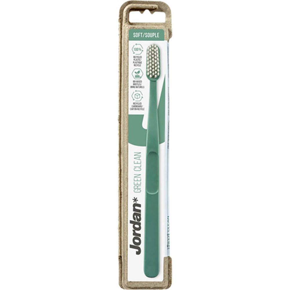 Brosse à dents dans son emballage. Manche vert, tête blanche. Marque Jordan Green Clean. Emballage en carton.