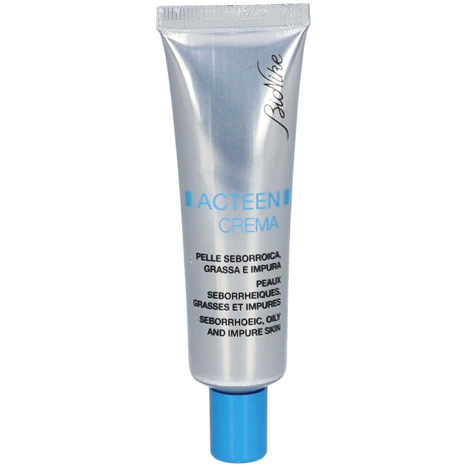 Tube argentée, bouchon bleu. Inscription Acteen Crema, Bionike. Pour peaux séborrhéiques, grasses et impures.