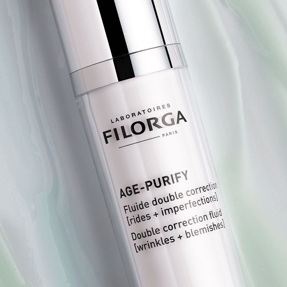 Gros plan sur le flacon. Logo FILORGA et AGE-PURIFY. Texte : Double correction fluid.