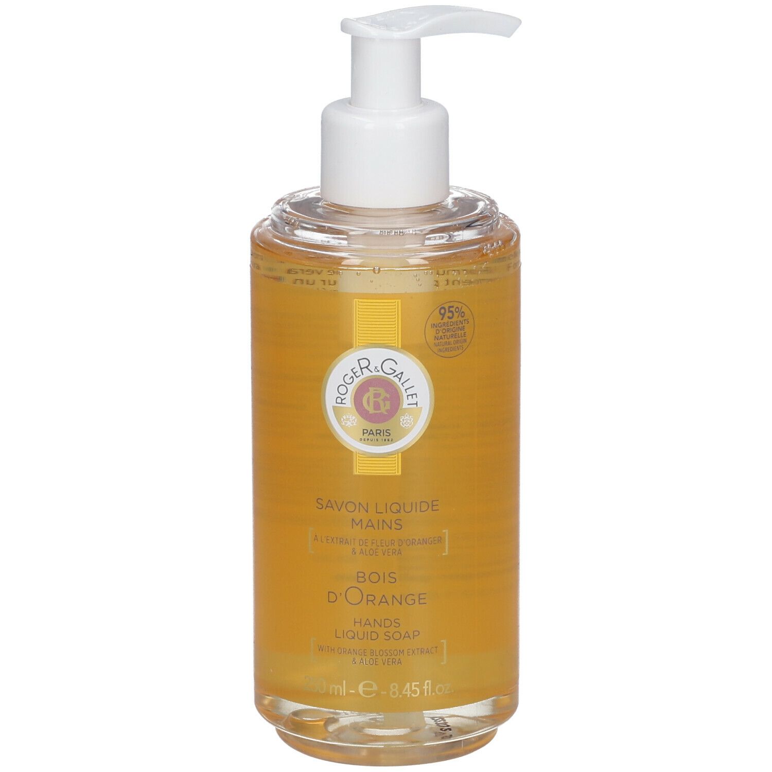 Savon liquide avec pompe. Récipient transparent avec liquide jaune. Inscription: Savon Liquide Mains, Bois d'Orange, 95% d'ingrédients d'origine naturelle.