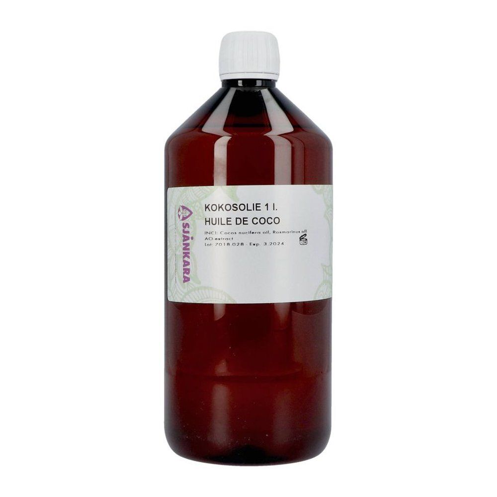 Bouteille marron avec bouchon blanc. Étiquette avec inscription Huile de Coco. Marque Sjankara.