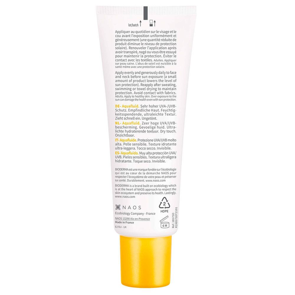 Tube de crème solaire, dos. Texte en allemand, français, italien, néerlandais. Bouchon jaune, tube blanc.