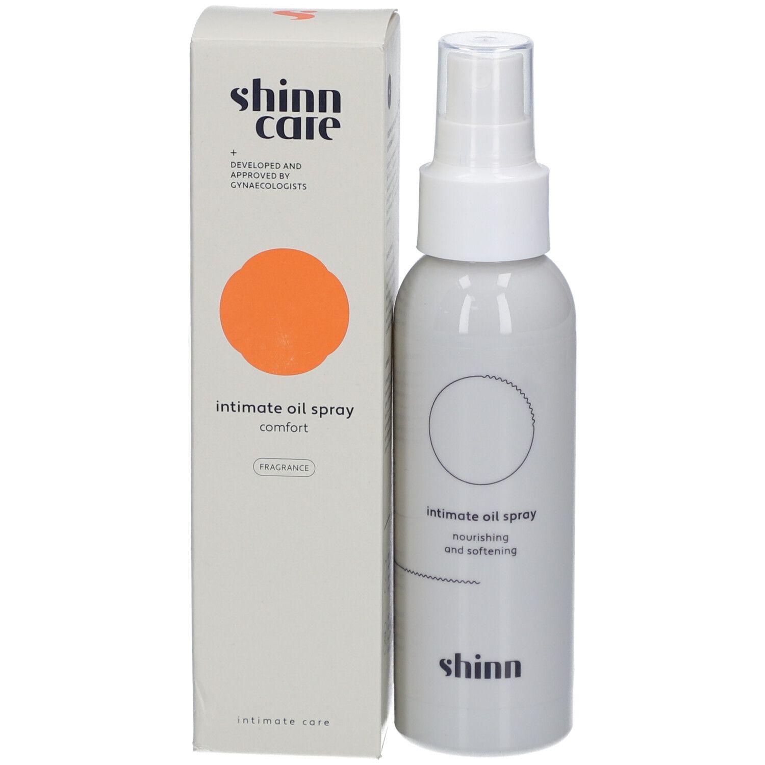Spray blanc avec tête de pulvérisation et emballage. Inscription : intimate oil spray comfort. Marque : shinn care. Cercle orange.