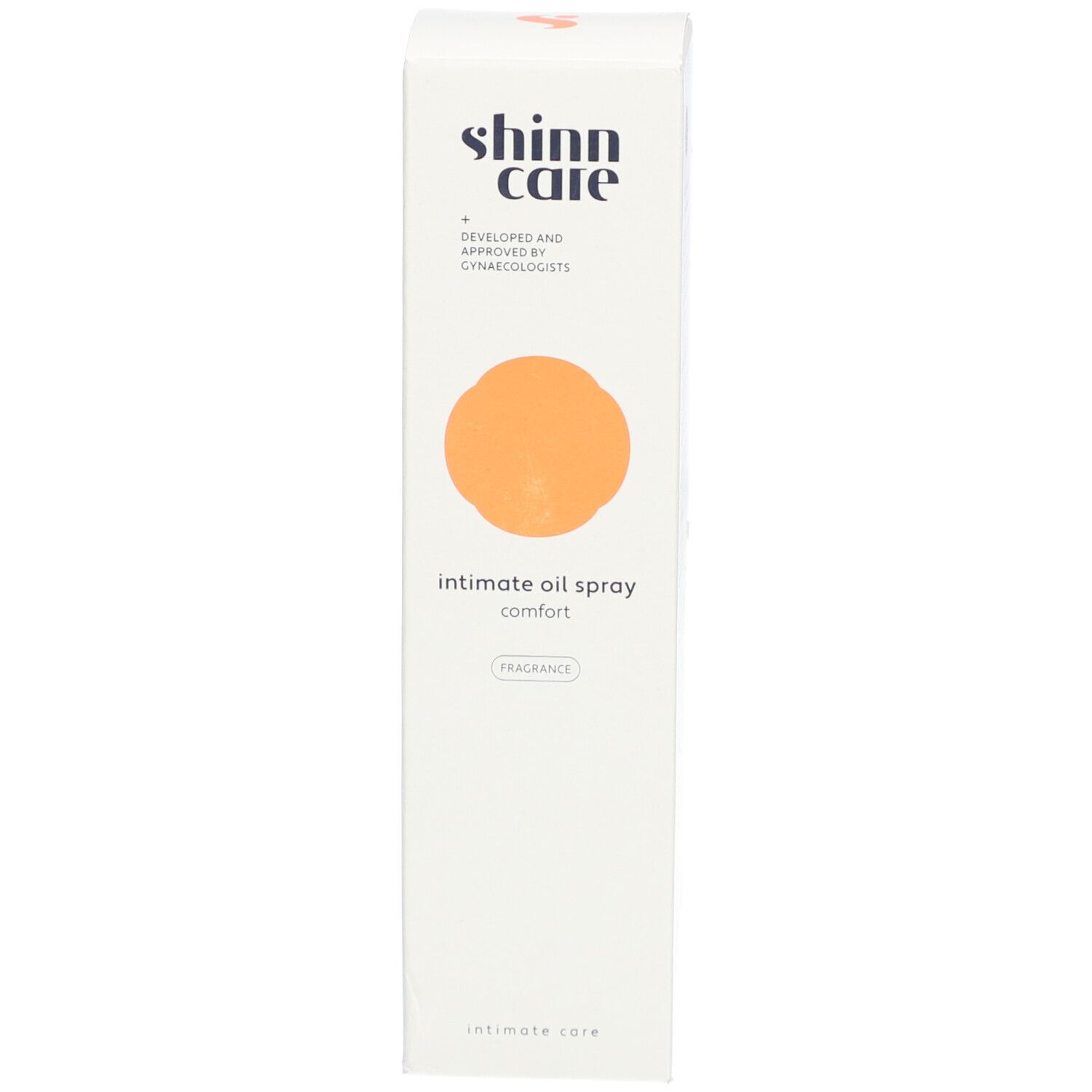 Emballage blanc et haut. Inscription : intimate oil spray comfort. Marque : shinn care. Cercle orange.
