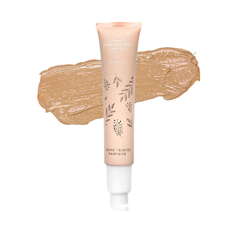Tube de crème CC et produit. Inscriptions: Cent Pur Cent, Nomige. Produit sur fond blanc.