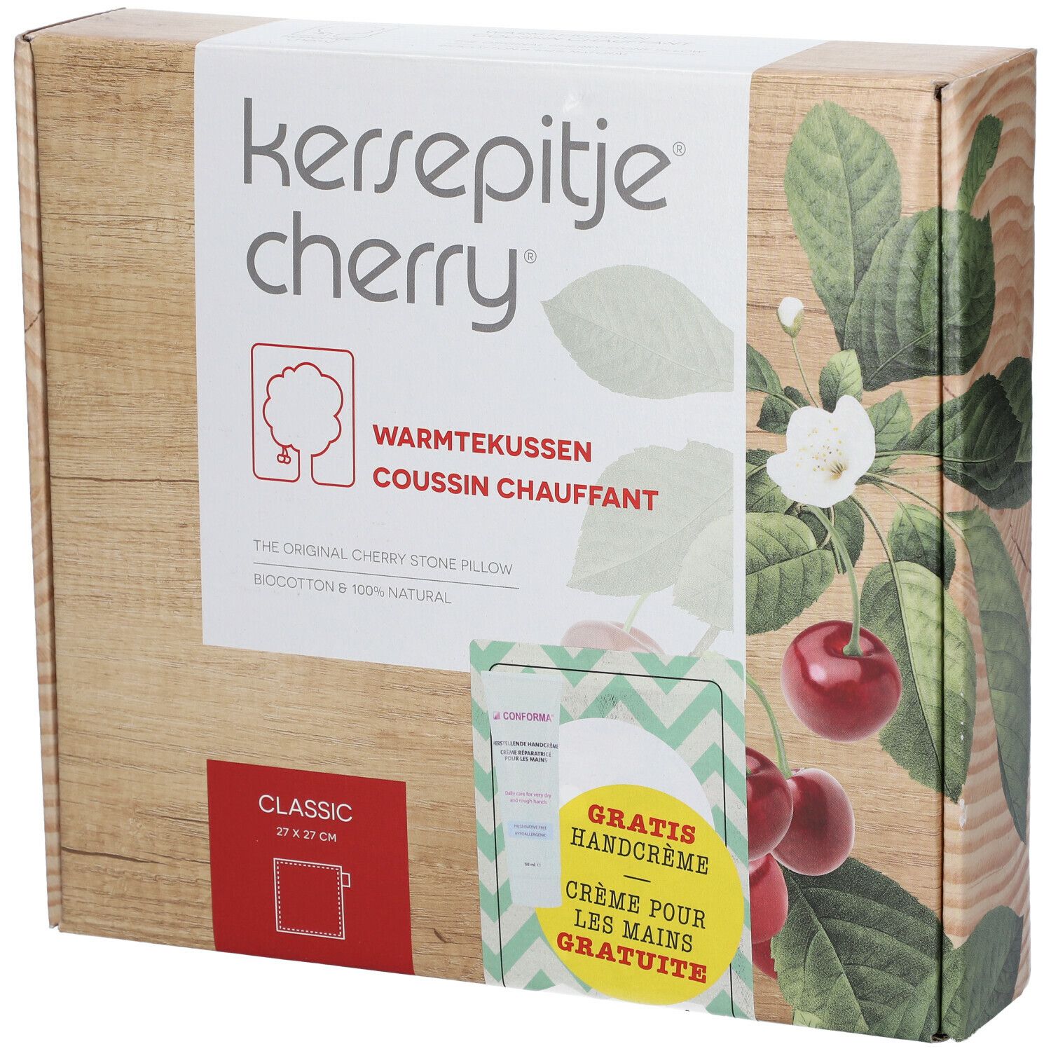 Emballage avec nom du produit et cerises. Contient un coussin aux noyaux de cerises et une crème pour les mains. Texte : Crème pour les mains GRATUITE.