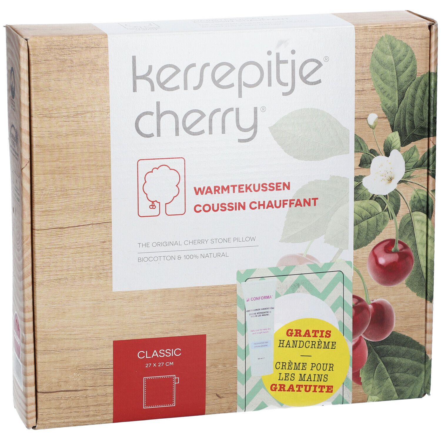 Emballage avec nom du produit et cerises. Contient un coussin aux noyaux de cerises et une crème pour les mains. Texte : Crème pour les mains GRATUITE.