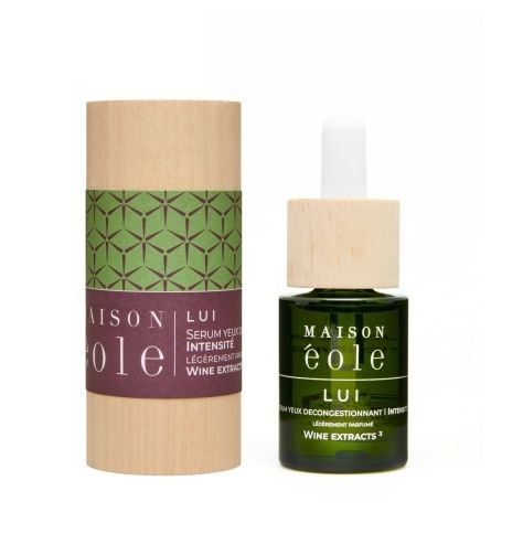 Flacon et emballage. Flacon en verre vert avec bouchon en bois. Emballage cylindrique avec inscription: Maison Éole.