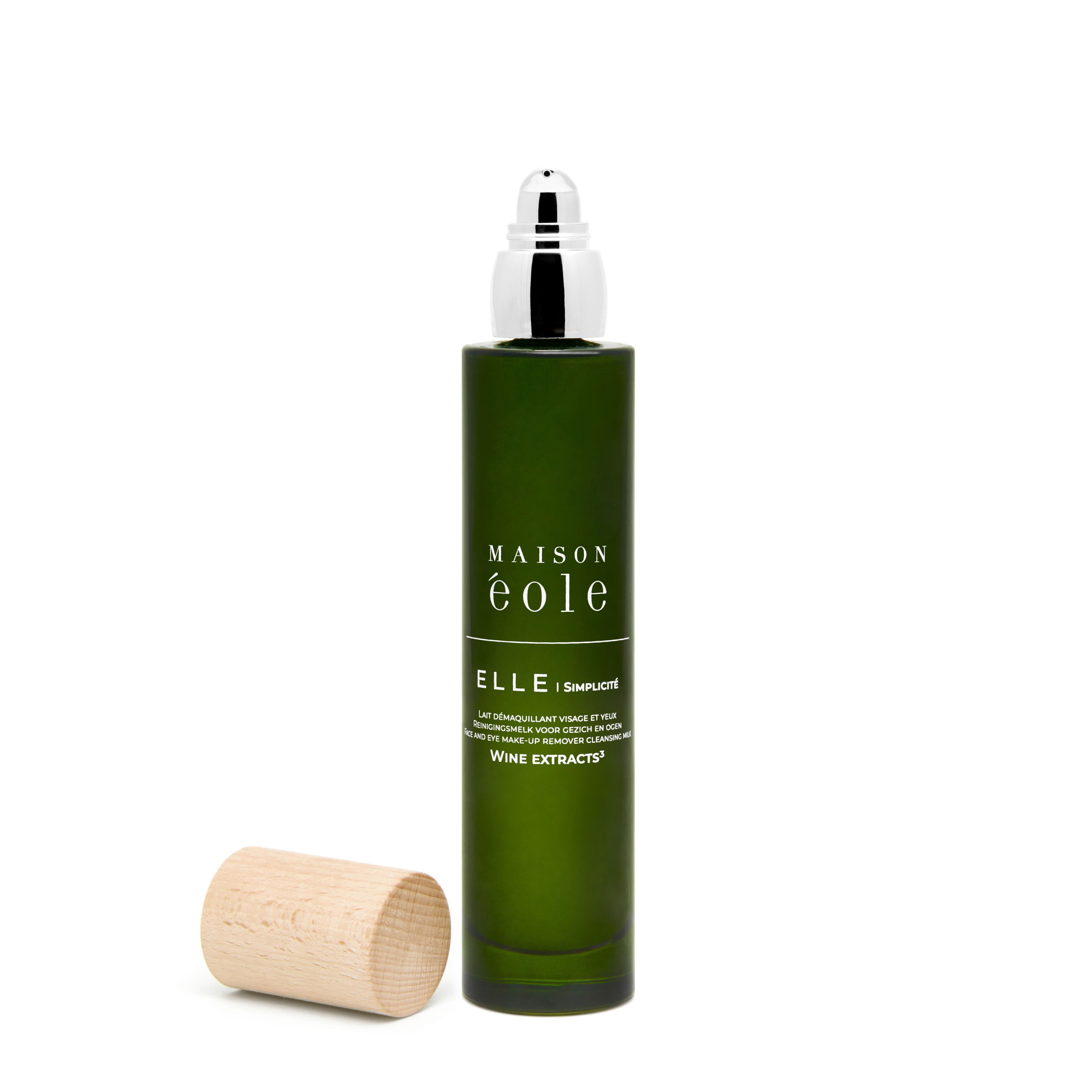 Flacon vert avec pompe argentée et bouchon en bois. Inscription: Maison Éole, ELLE/SIMPLICITÉ.