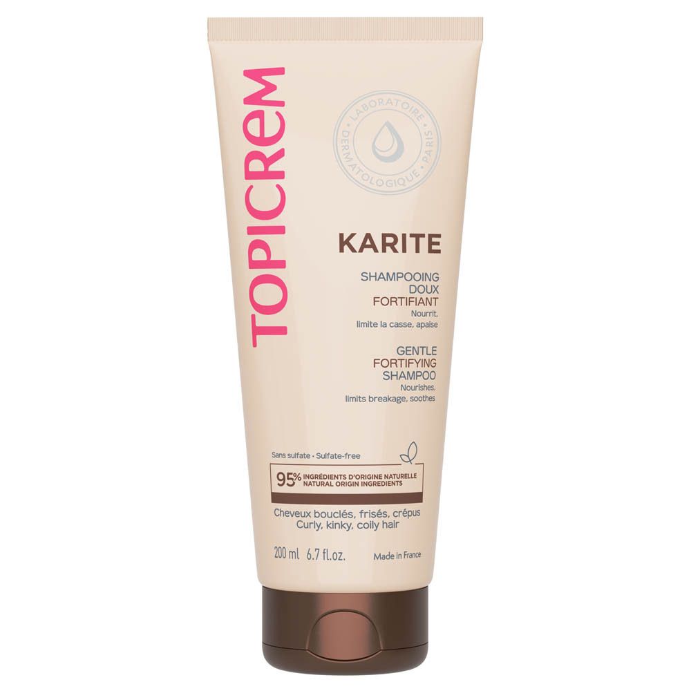 Tube beige avec inscription rose TOPICREM. KARITE SHAMPOOING DOUX FORTIFIANT, GENTLE FORTIFYING SHAMPOO. Contient 95% d'ingrédients naturels. Pour cheveux bouclés.