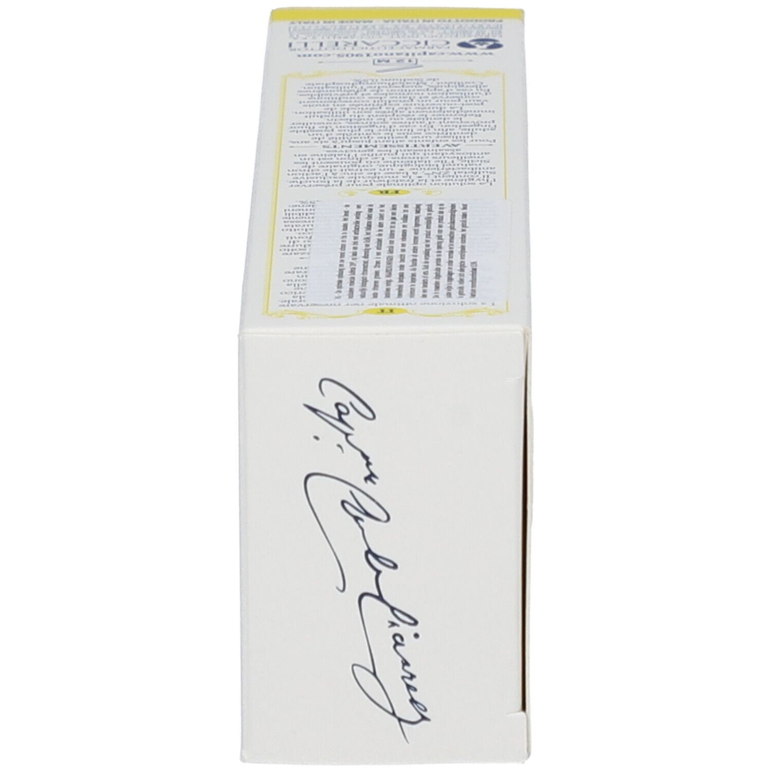 Côté de la boîte avec signature et texte. Fond jaune.