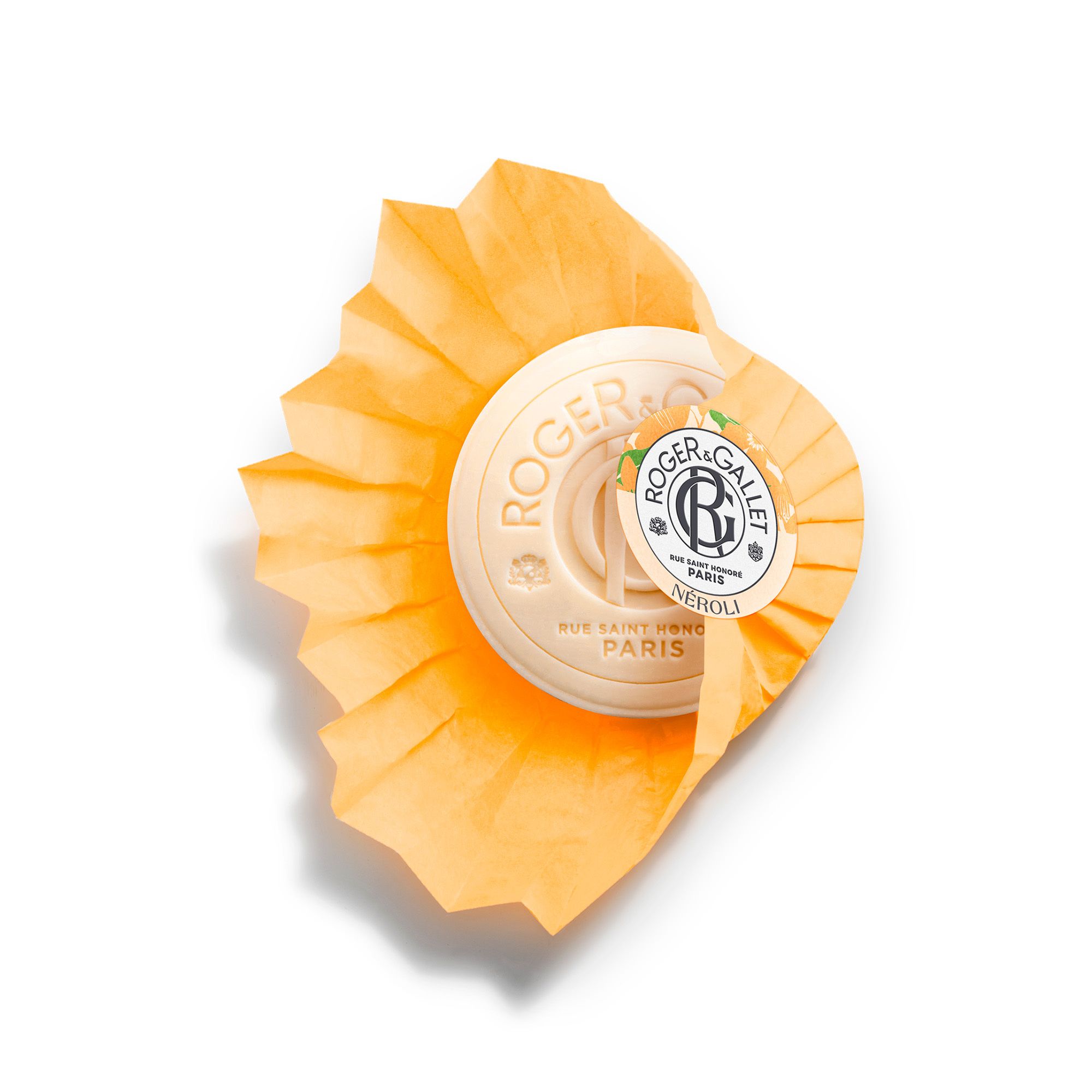 Savon rond orange avec papier. Marque Roger & Gallet, Néroli. Vue de dessus.