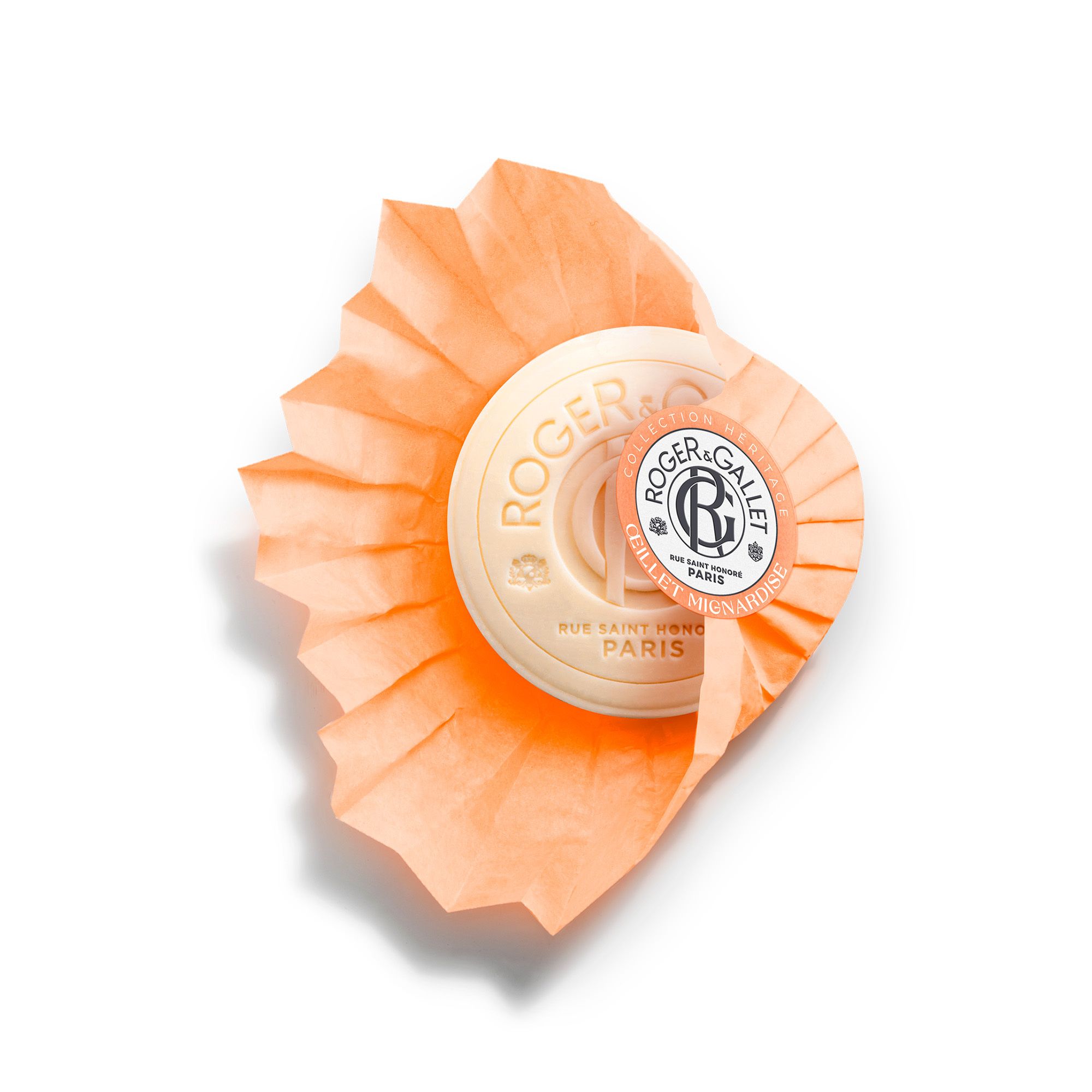 Savon rond orange avec logo. Savon emballé dans du papier orange. Texte: Roger & Gallet.