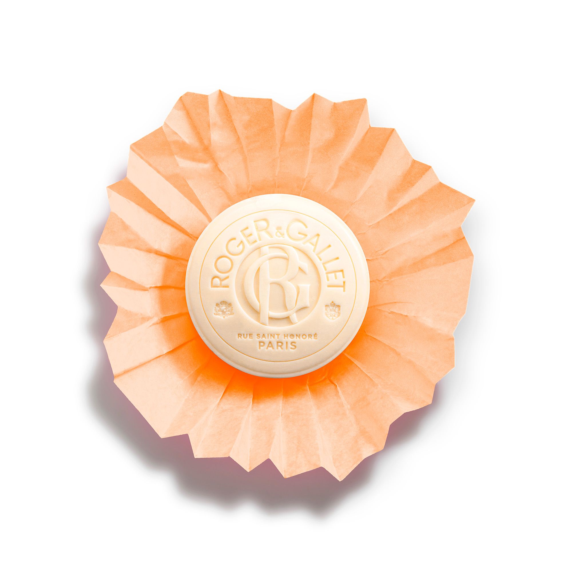 Savon rond orange avec logo. Savon emballé dans du papier orange. Texte: Roger & Gallet.