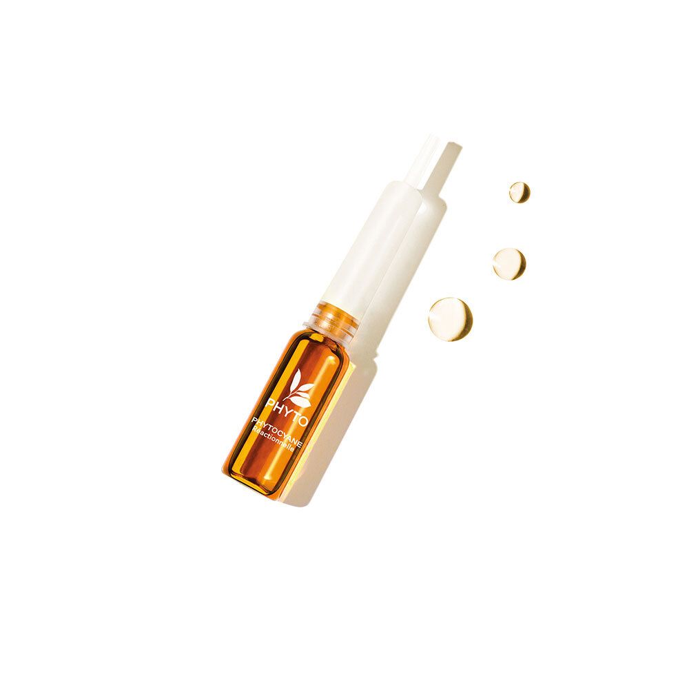 Une ampoule ambrée avec applicateur blanc. Inscription: Phyto Phytocyane.