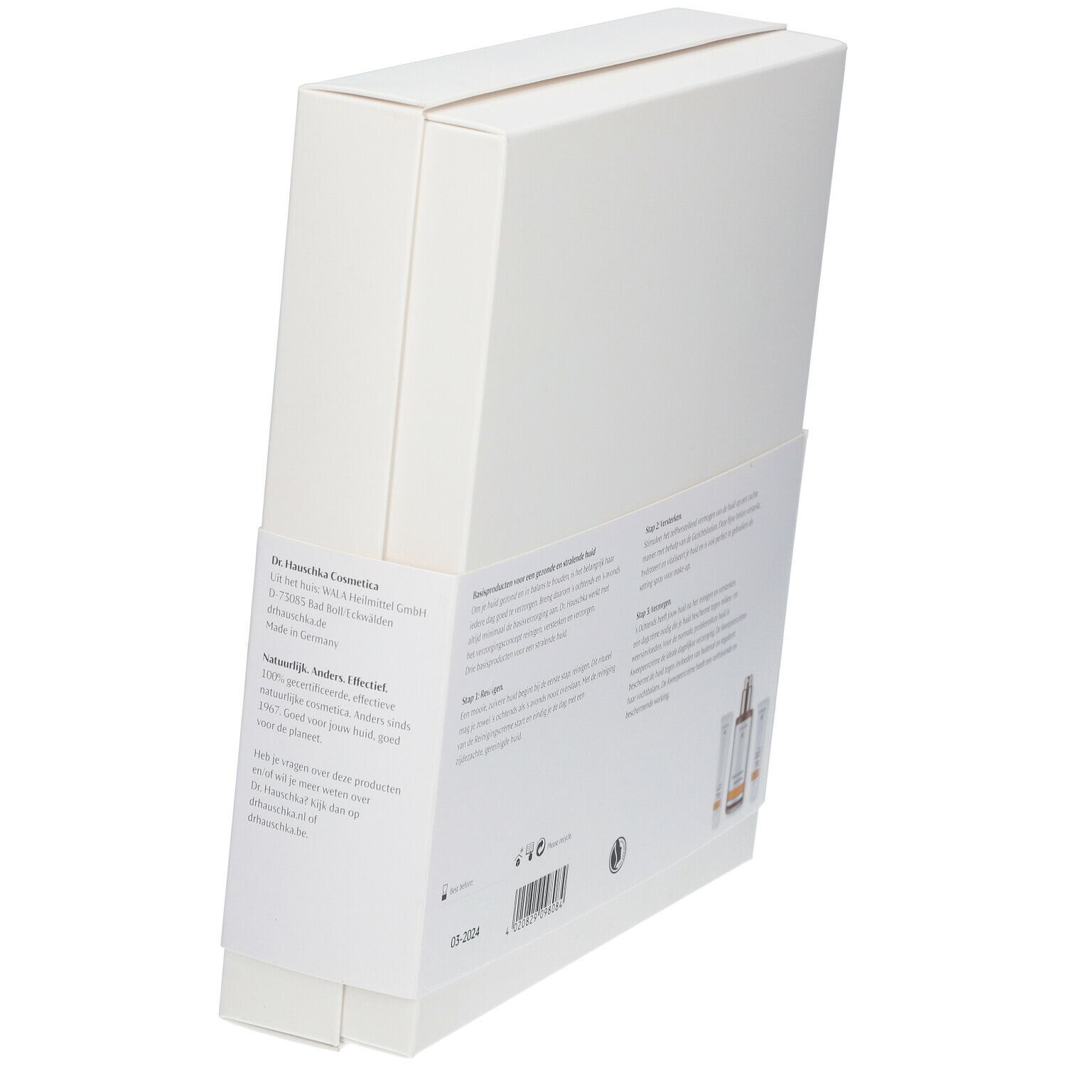 Coffret blanc, vue latérale. Texte et illustrations de produits. Logo Dr. Hauschka. Texte en néerlandais.