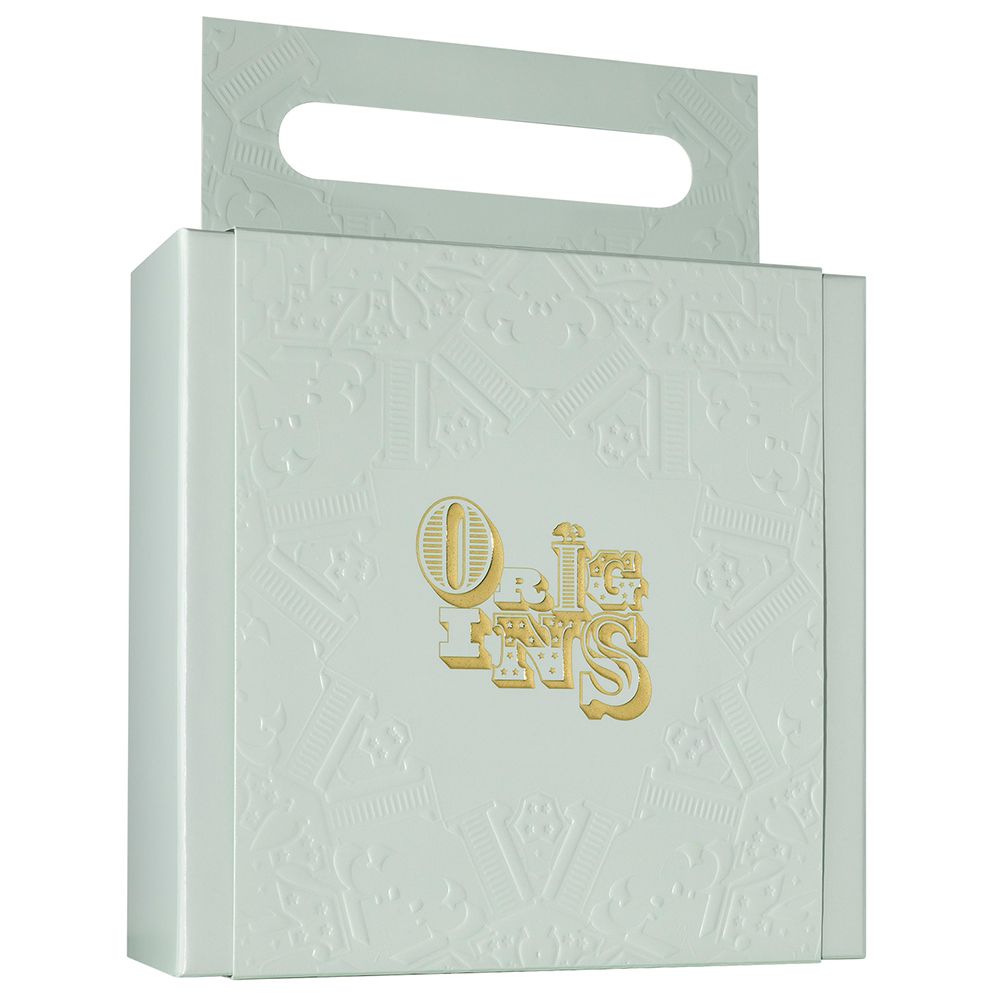 Coffret cadeau blanc avec gaufrage et poignée. Inscription dorée "ORIGINS" sur le devant.