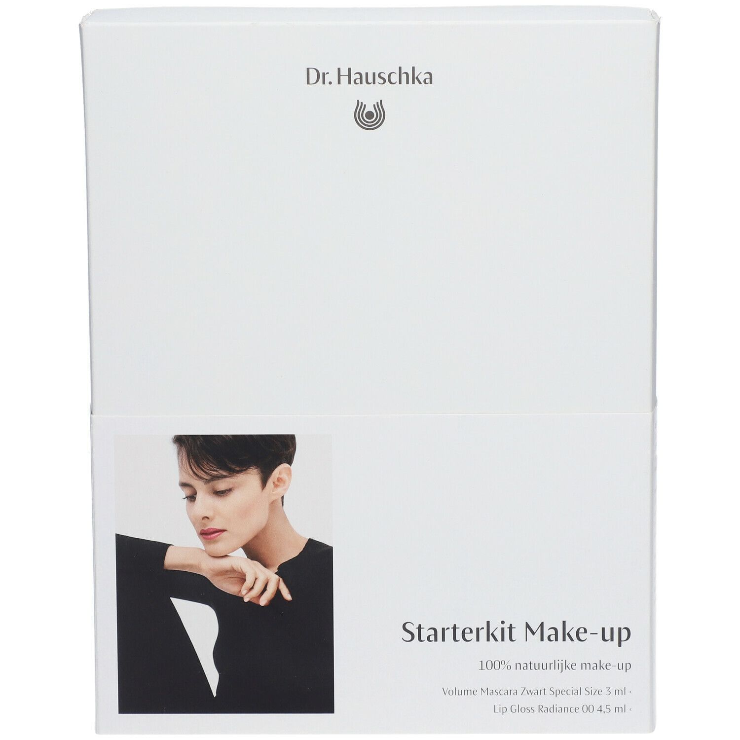 Emballage blanc avec nom du produit et modèle. Contient un kit de maquillage de démarrage. Marque : Dr. Hauschka. Texte : Volume Mascara, Lip Gloss.