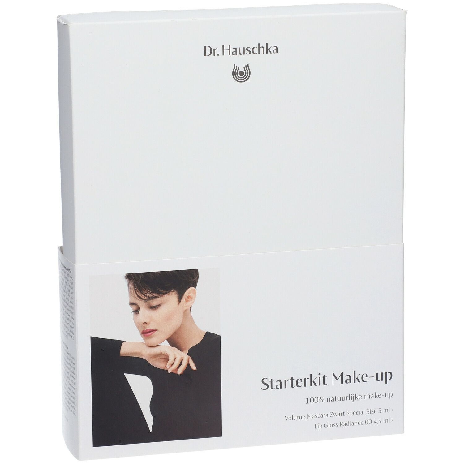 Emballage blanc avec nom du produit et modèle. Contient un kit de maquillage de démarrage. Marque : Dr. Hauschka. Texte : Volume Mascara, Lip Gloss.