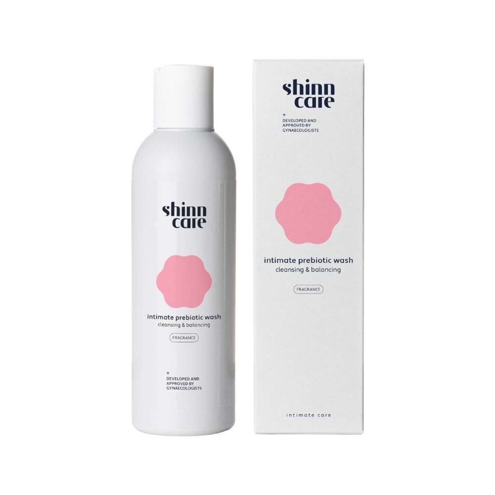 Emballage produit avec flacon et carton. Logo Shinncare, nom du produit et design floral rose.