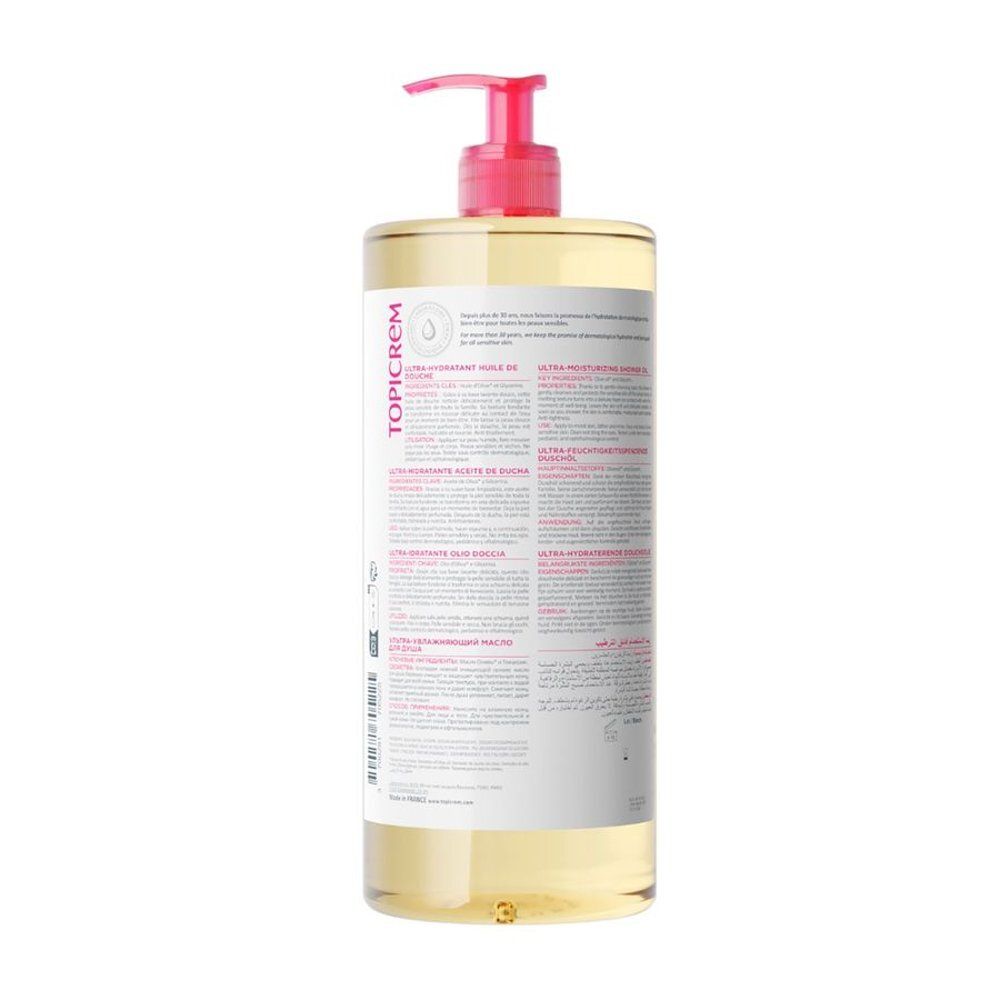 Dos du flacon d'huile de douche Topicrem Ultra Hydratant. Texte multilingue. Inscriptions roses et blanches.