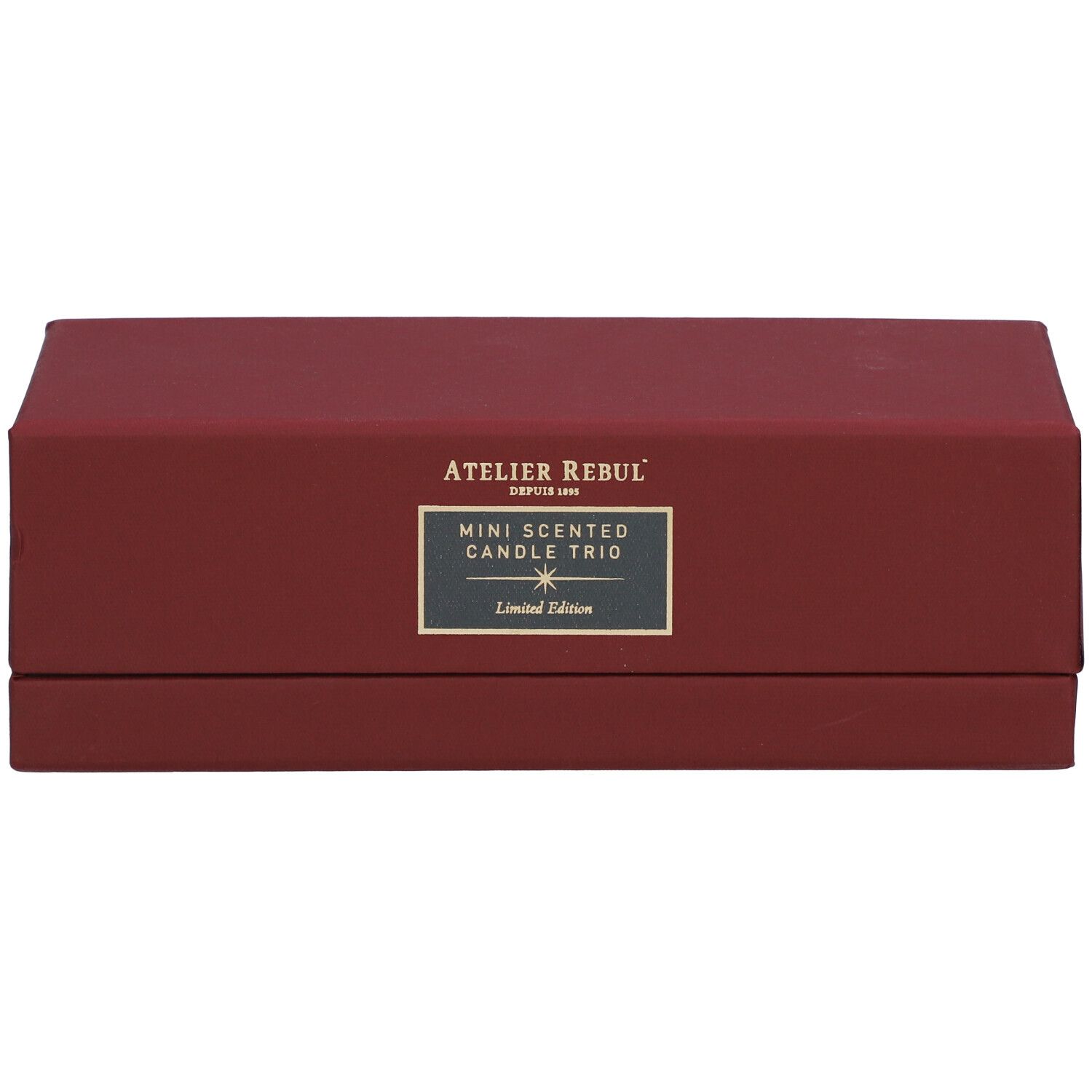 Boîte rectangulaire rouge avec 'ATELIER REBUL' et 'MINI SCENTED CANDLE TRIO'. 'Limited Edition' en dessous.