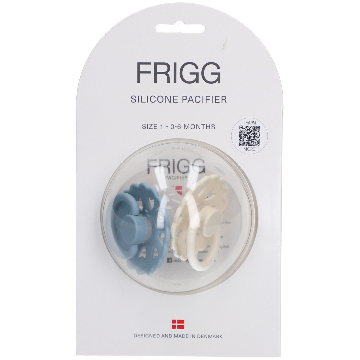 Deux sucettes FRIGG en emballage. Bleue et crème. Taille 0-6 mois. Sucettes en silicone.
