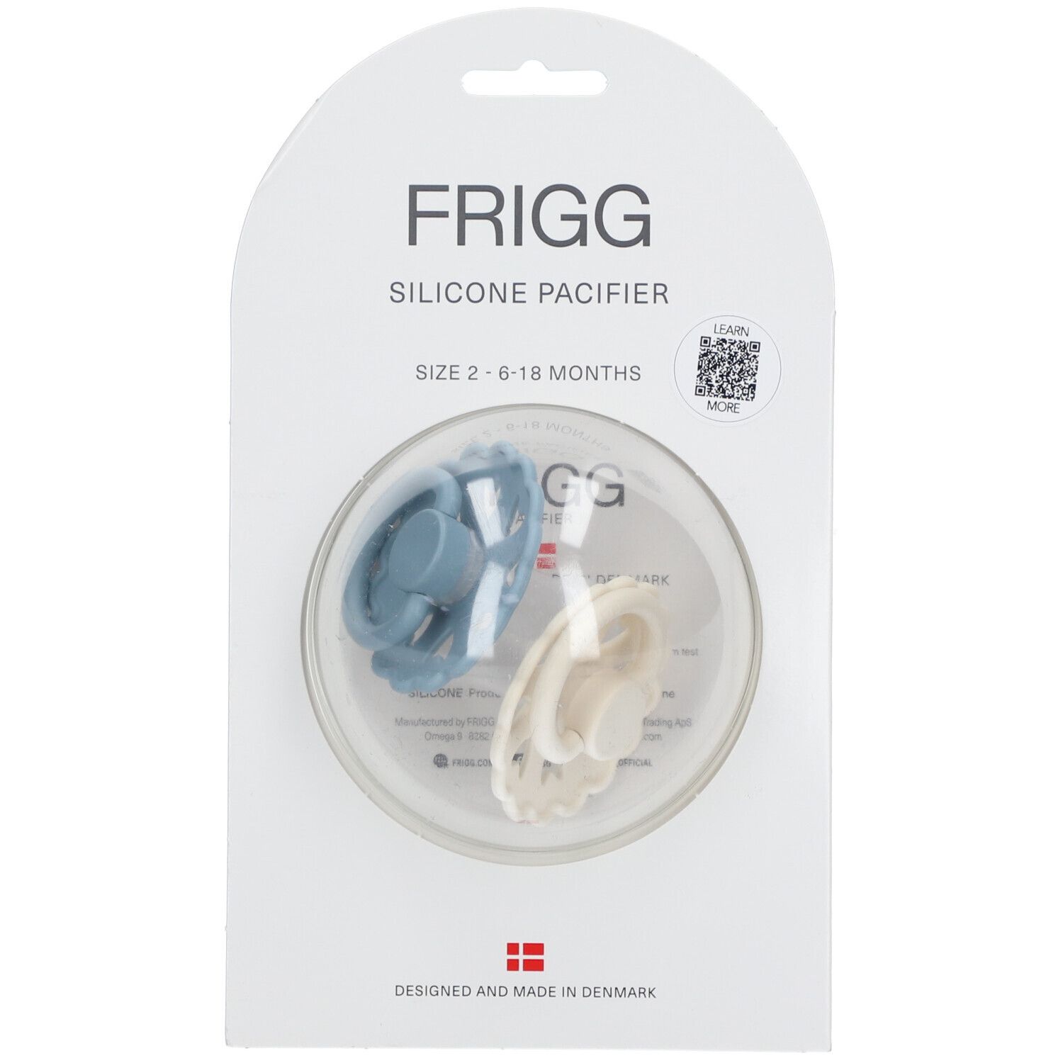 Deux sucettes bleues et crème dans un emballage transparent. Inscription : FRIGG, sucette en silicone, taille 2, 6-18 mois.