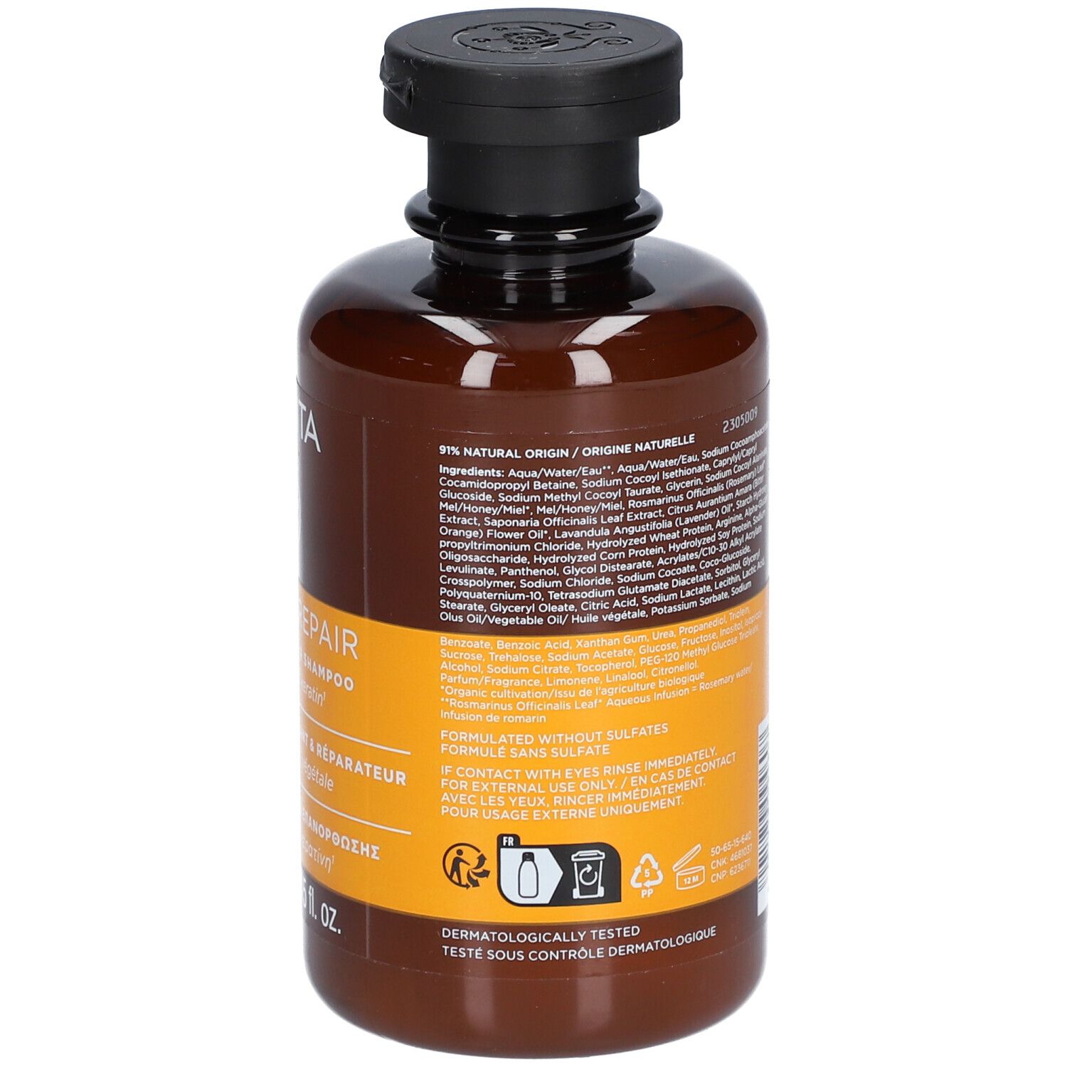 Flacon de shampoing brun avec bouchon noir et étiquette indiquant les ingrédients et les instructions.