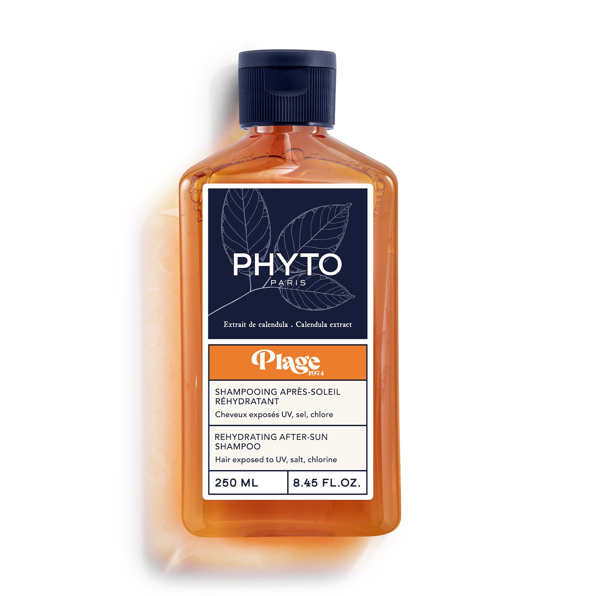 Flacon de shampooing orange, bouchon bleu. Inscriptions : Phyto Paris, Plage, Après-Soleil. 250 ml.