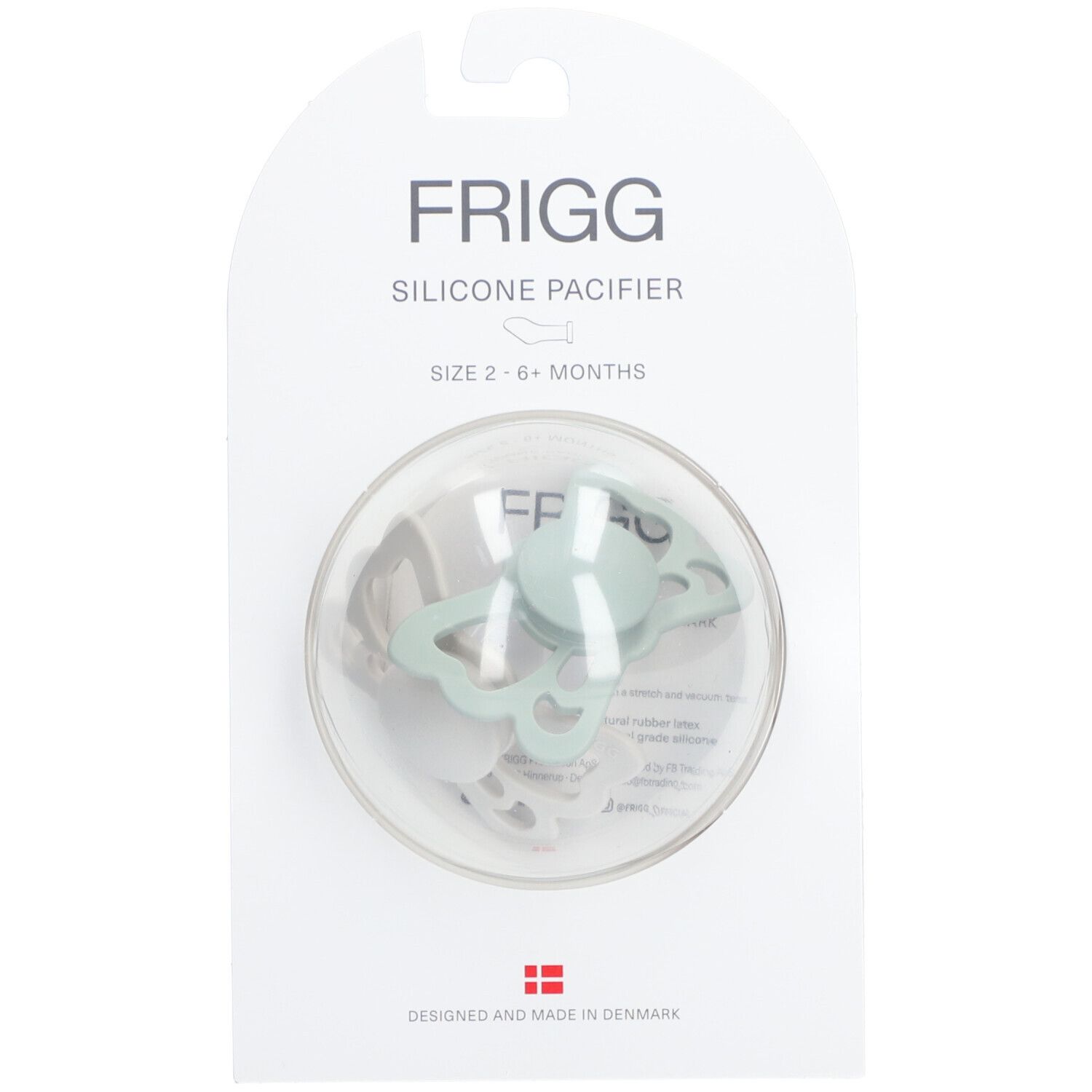 Sucette papillon en silicone dans un emballage. Tétine vert clair dans un blister transparent. Marque FRIGG.
