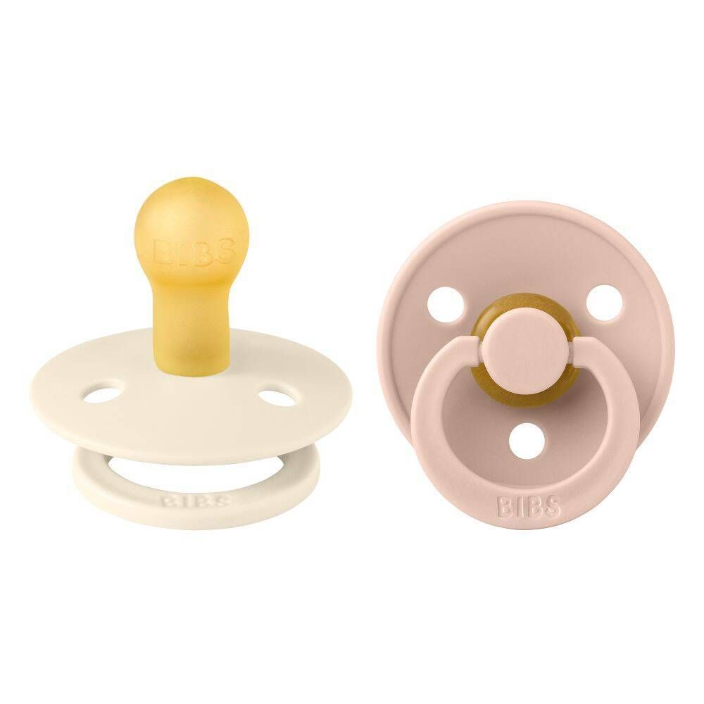 Deux sucettes. Ivoire et rose. Forme ronde. Tétine jaune. Marque BIBS.
