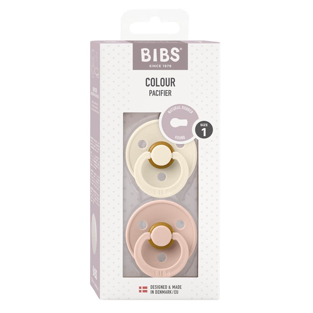 Boîte de deux sucettes BIBS. Couleurs ivoire et rose. Fenêtre transparente. Texte: Colour Pacifier, taille 1.
