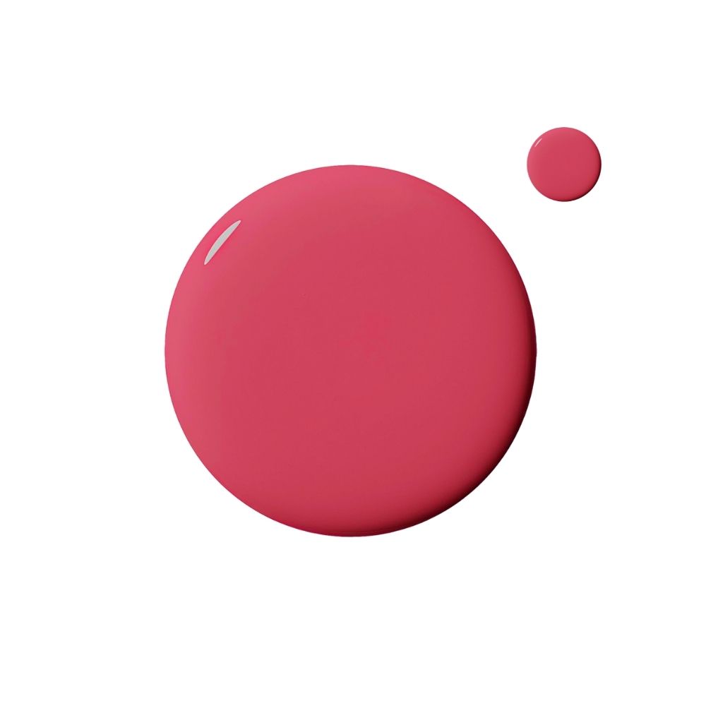 Deux gouttes de vernis à ongles roses sur fond blanc. Une grande et une petite goutte.