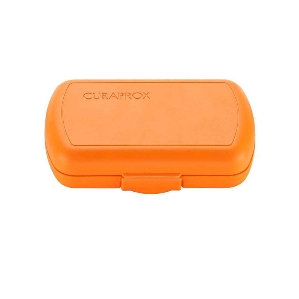 Boîte de rangement CURAPROX orange avec couvercle.