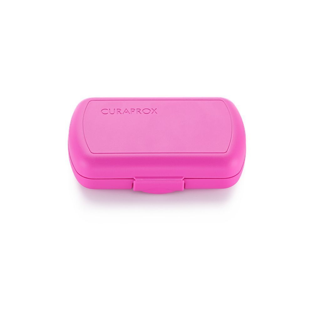 Trousse de voyage rose fermée. Marque Curaprox. Forme rectangulaire aux coins arrondis.
