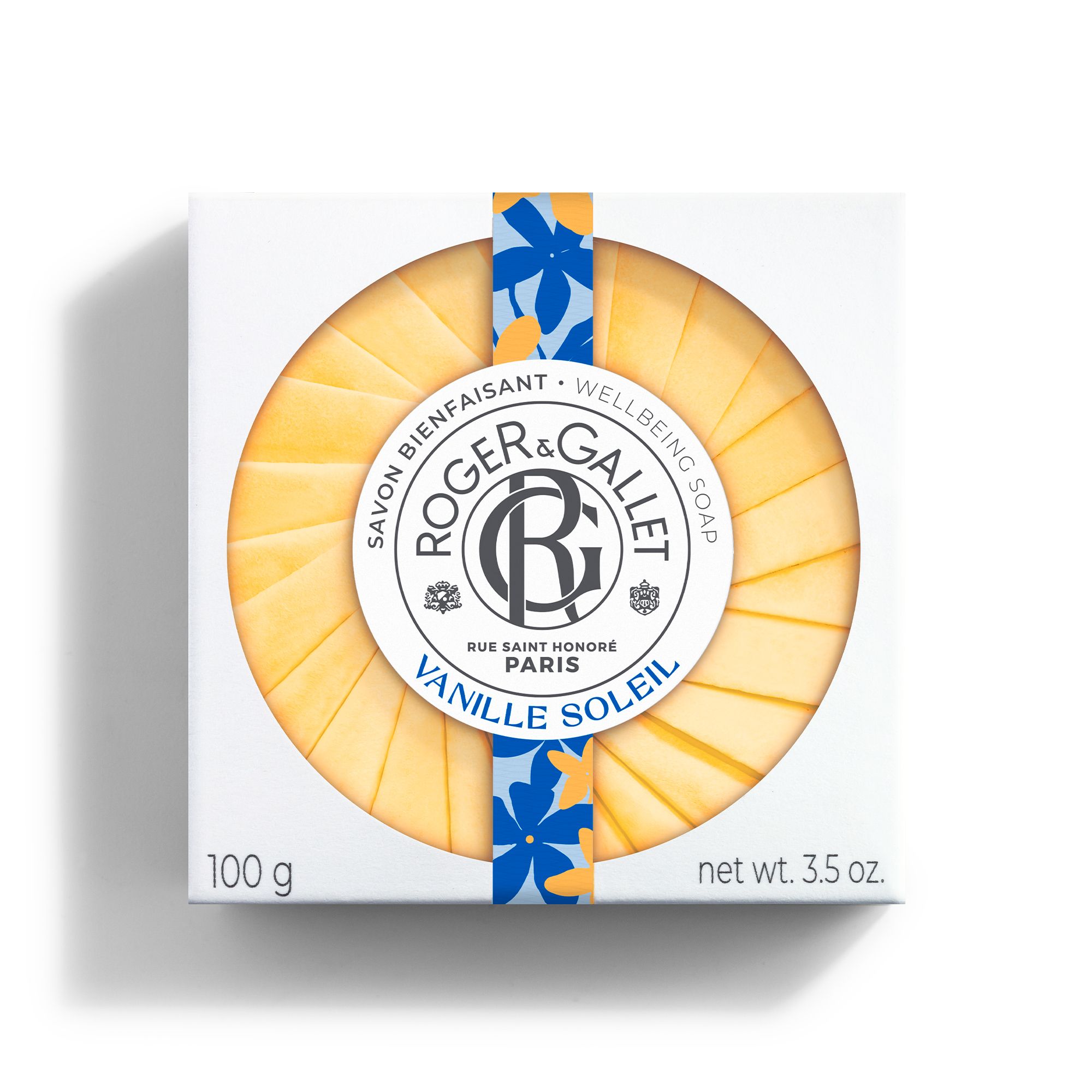 Boîte blanche avec savon rond. Inscription: Roger & Gallet Vanille Soleil. Emballage papier jaune.
