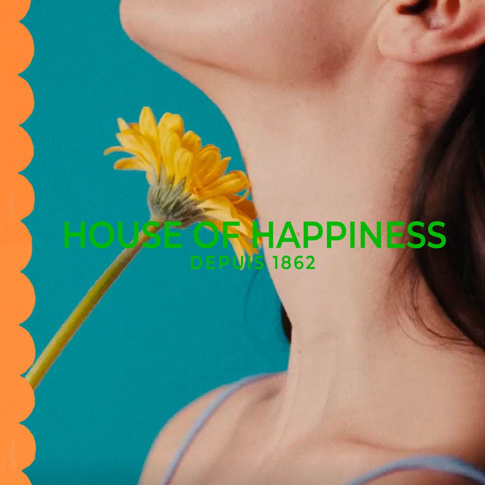 Femme avec fleur. Texte: House of Happiness. Depuis 1862.
