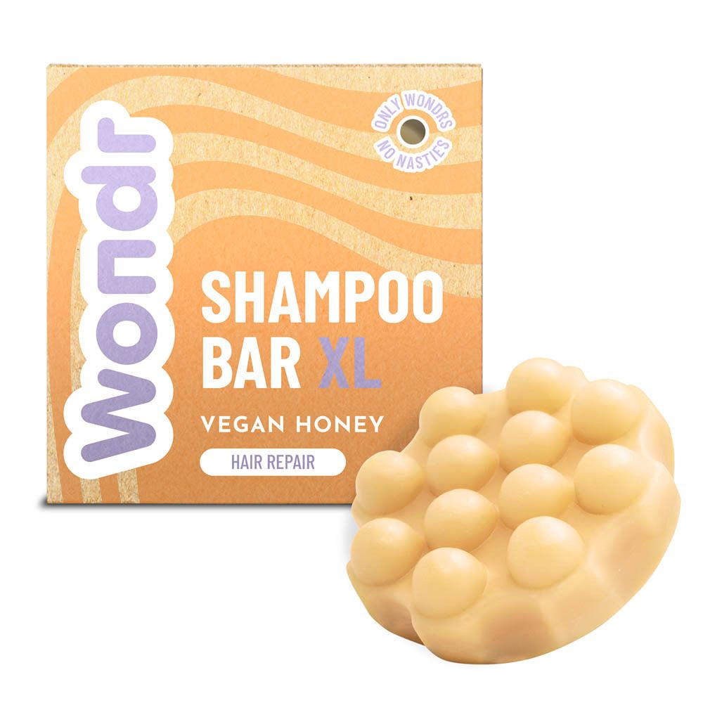 Emballage en carton et barre de shampooing. Barre jaune clair avec cercles en relief. Emballage Wondr.