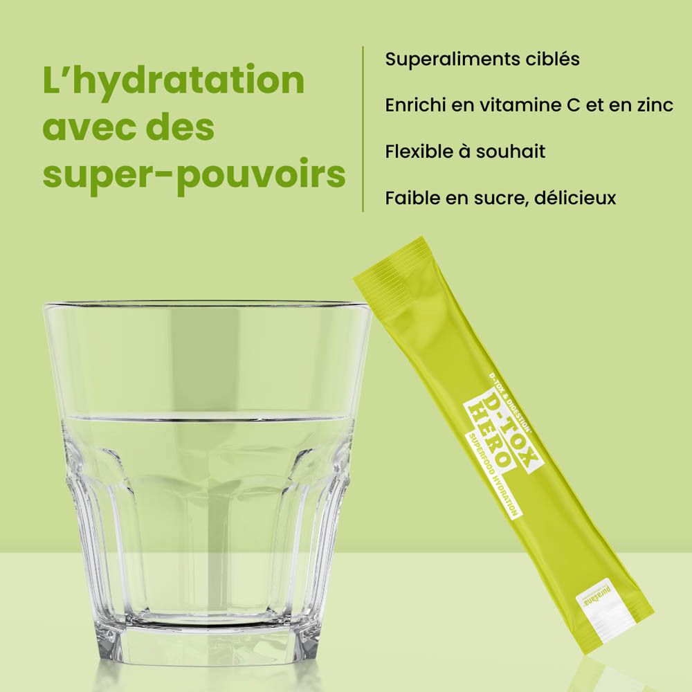 Boîte verte avec produit. Inscription: D-Tox Hero, Superfood Hydration. 10 sticks. Ingrédients: Gingembre, Curcuma, Enzymes, Vitamine C.