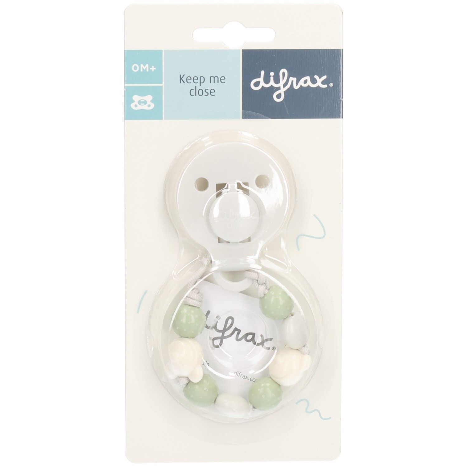 Sucette blanche avec perles vertes et blanches, emballage blister. Marque: Difrax. Inscription: Keep me close.