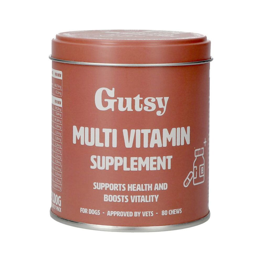Boîte ronde marron avec texte blanc "Gutsy Multi Vitamin Supplement". Contient 80 comprimés à mâcher. Pour chiens.