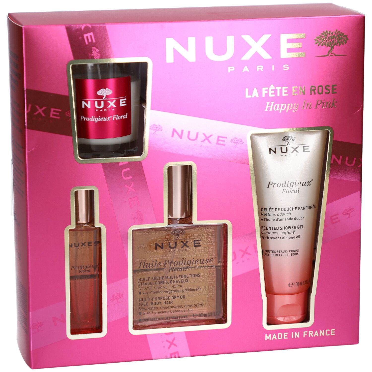Coffret rose avec quatre produits. Visibles : flacon, huile, gel douche et bougie. Logo et texte Nuxe.