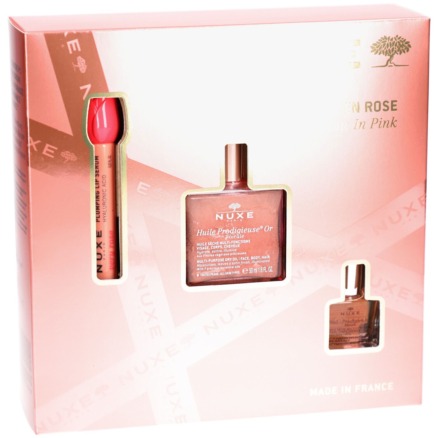 Coffret cadeau rose avec trois produits. Visibles: rouge à lèvres, flacon d'huile et petit flacon. Texte: Nuxe Paris, Glow en Rose.