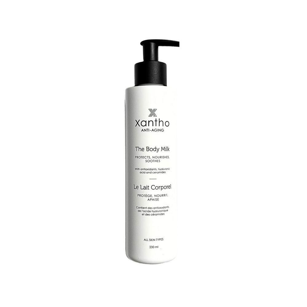 Flacon blanc avec pompe noire. Inscription: Xantho Anti-Aging, The Body Milk, Le Lait Corporel. 230 ml.