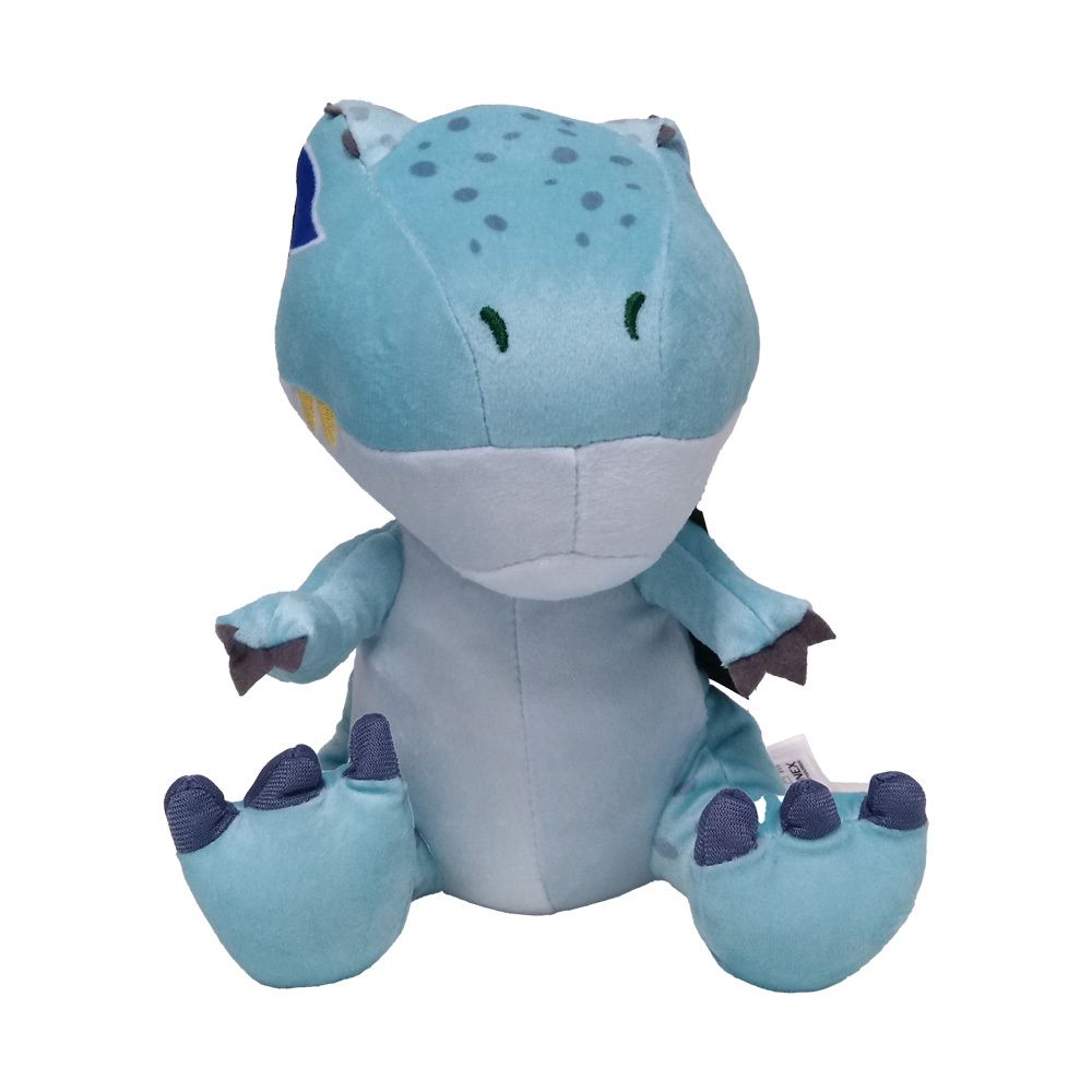 Dinosaure en peluche bleu clair, assis. Taches et détails bleu foncé. Petits bras et jambes. Fond blanc.